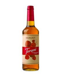 Torani Puremade Hazelnut Syrup in a glass bottle with hazelnut illustrations on the label
