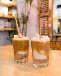 Two blended coffees on a table in a cafe.