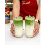 Two Banana Matcha Lattes placed on a table.