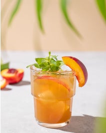 Bourbon Apricot cocktail with fruit and mint.
