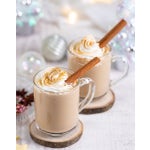 Two lattes in mugs with whipped cream and cinnamon sticks.