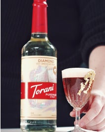 Cup of sparkling espresso on a table.